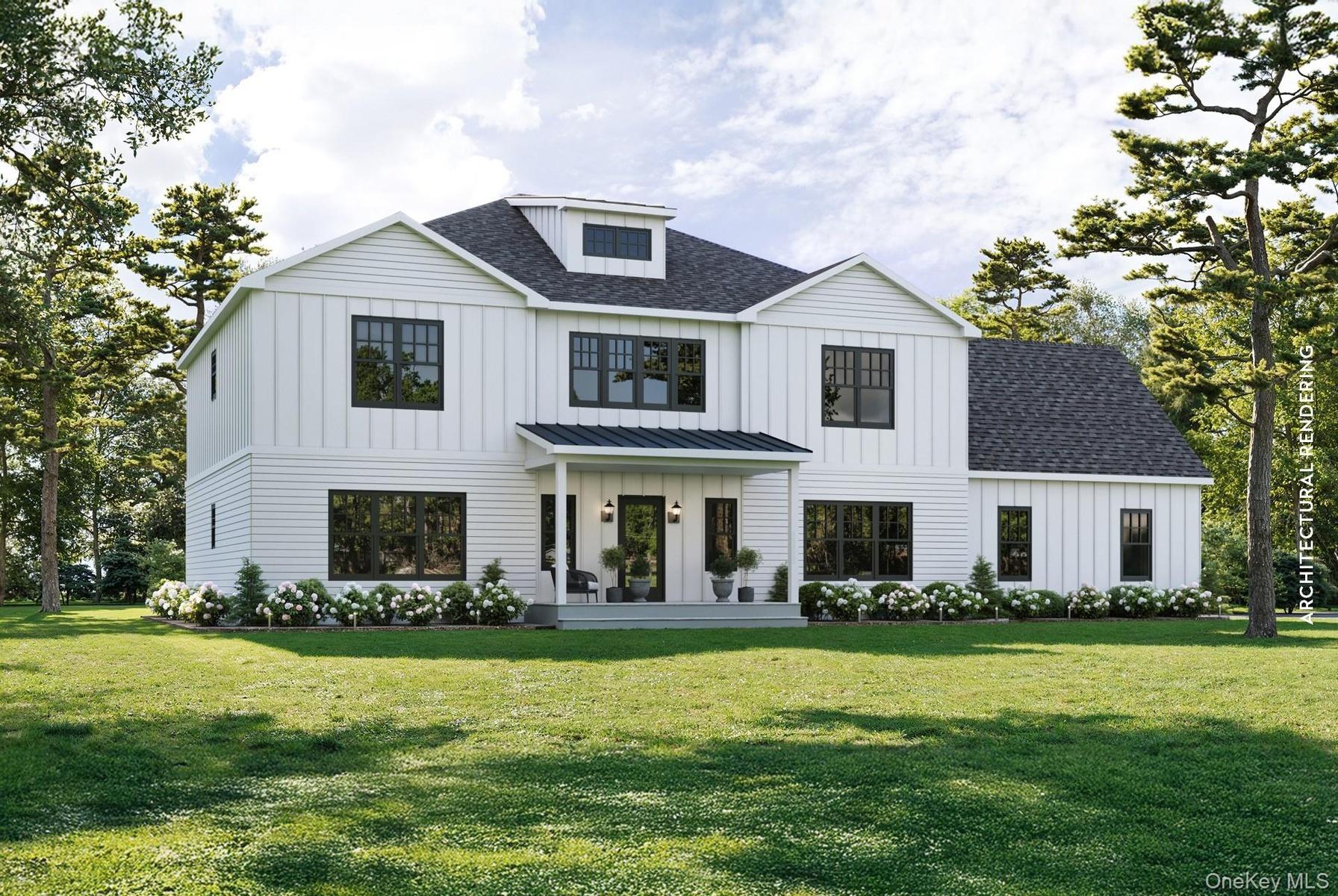 View of front of home with board and batten siding, a shingled roof, covered porch, and a front yard