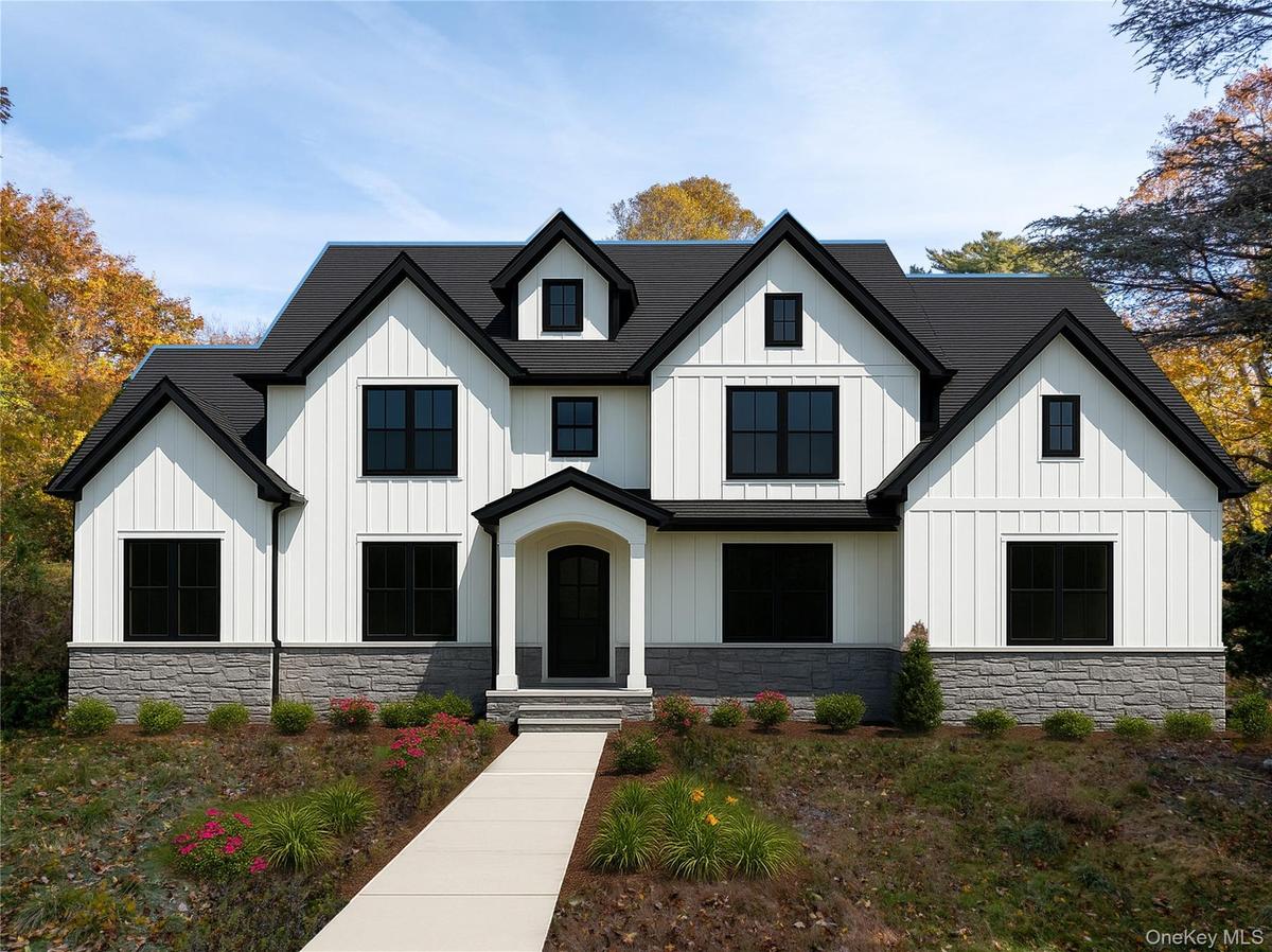 View of front facade with board and batten siding and stone siding