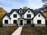 View of front facade with board and batten siding and stone siding