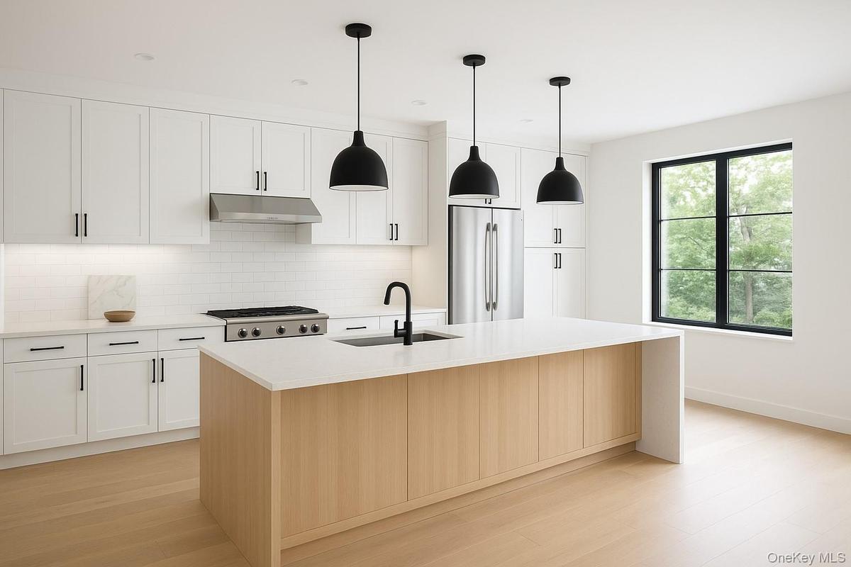 Kitchen featuring tasteful backsplash, stainless steel refrigerator, decorative light fixtures, and light stone countertops