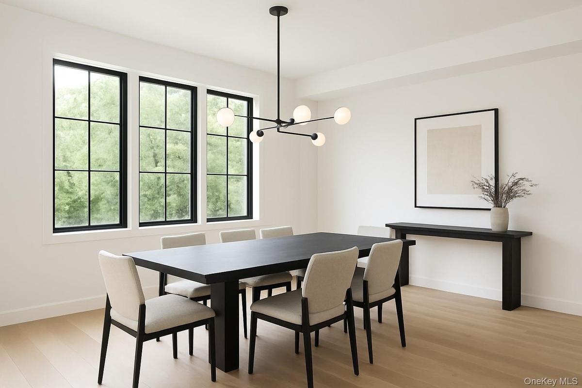 Dining area with light wood finished floors and a chandelier