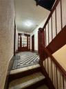 Staircase featuring a textured wall, ornamental molding, and a textured ceiling