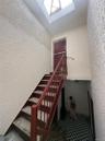 Stairs with a textured wall and tile patterned floors