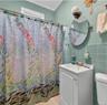 Bathroom with tile walls, vanity, crown molding, and a shower with shower curtain
