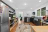 Kitchen with stainless steel appliances, light wood-style flooring, dark cabinets, recessed lighting, and modern cabinets