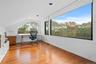 Unfurnished office with light wood-style floors and vaulted ceiling