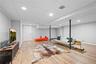 Living room with a drop ceiling, light wood-style flooring, and recessed lighting