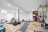 Workout room featuring wood finished floors, a paneled ceiling, and recessed lighting