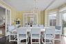 Dining room featuring an inviting chandelier, dark wood-type flooring, and french doors