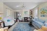 Living room with chandelier, crown molding, fireplace, and  hardwood floors