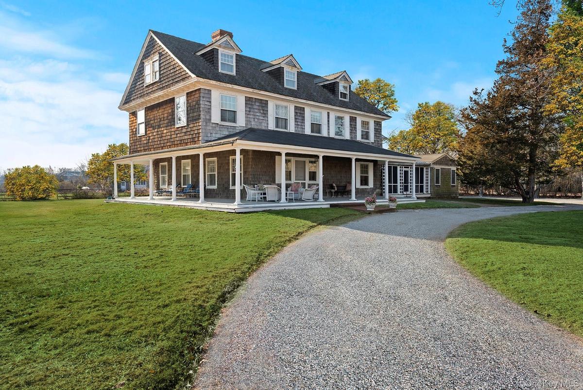 View of front of property with a covered porch and a front yard