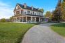 View of front of property with a covered porch and a front yard