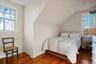 Guest Apt. Bedroom featuring vaulted ceiling and hardwood flooring