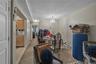 Dining room with light carpet, a textured ceiling, a chandelier, and a baseboard heating unit