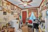 Home office featuring a textured ceiling, light carpet, crown molding, and a ceiling fan