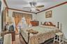 Bedroom with a textured ceiling, ceiling fan, ornamental molding, carpet, and a baseboard radiator