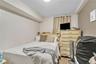 Bedroom with a textured ceiling and light carpet