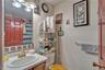 Bathroom with a shower with curtain and vanity