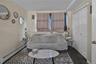 Carpeted bedroom featuring a baseboard heating unit, a textured ceiling, and a closet