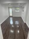Bedroom with dark wood finished floors and recessed lighting access to the patio