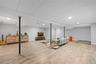 Finished below grade area featuring a paneled ceiling, light wood-style flooring, and recessed lighting