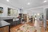 Kitchen featuring light wood-type flooring, ventilation hood, appliances with stainless steel finishes, tasteful backsplash, and recessed lighting