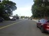 View of asphalt street featuring curbs and sidewalks