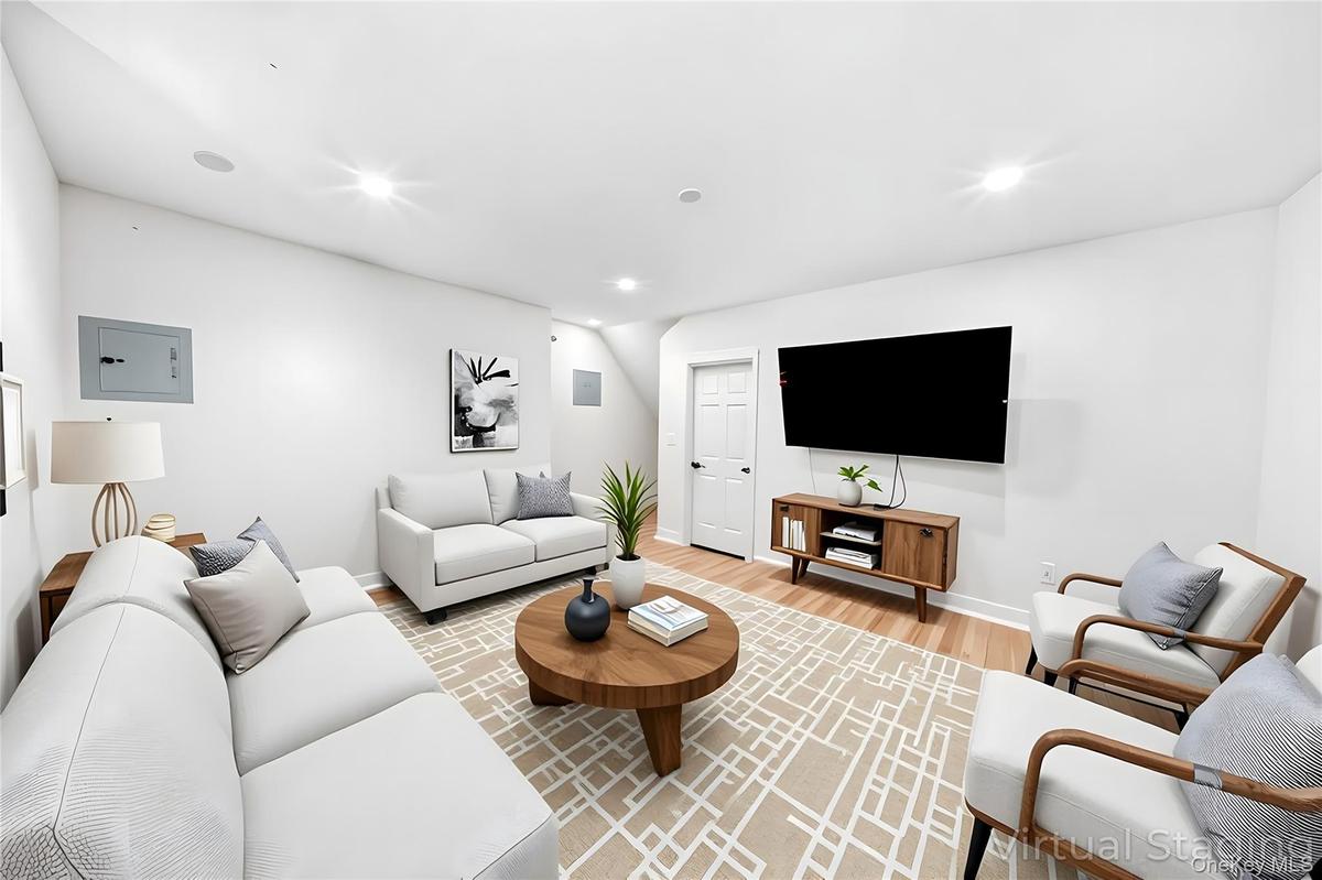 Living room featuring light wood-style floors and recessed lighting