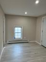 Unfurnished room with light wood-style floors, baseboard heating, and recessed lighting