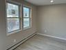 Spare room with a baseboard heating unit, light wood finished floors, and recessed lighting