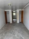 Unfurnished bedroom featuring multiple closets and concrete flooring
