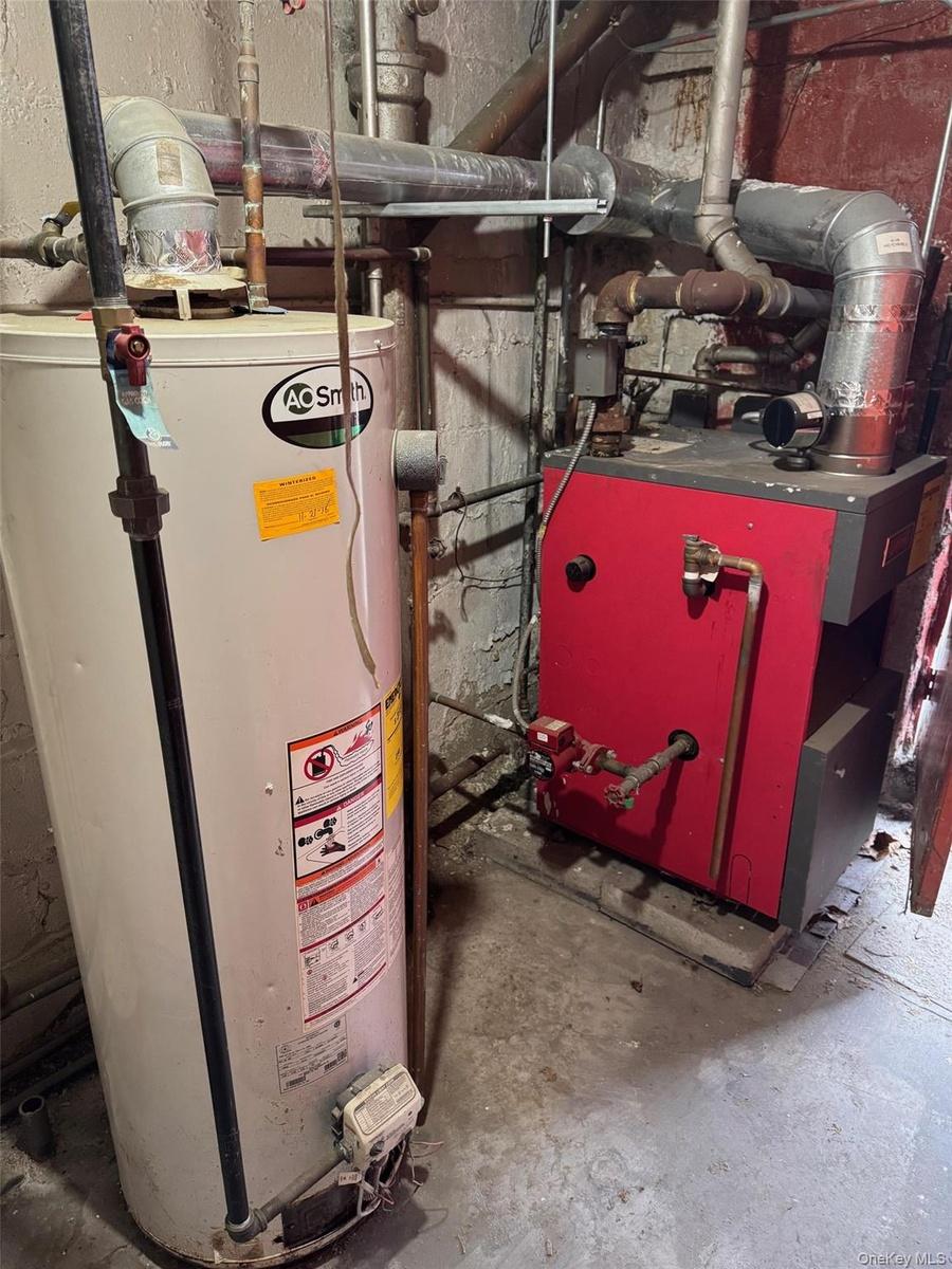 Utility room with gas water heater and a heating unit