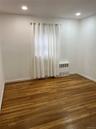 Empty room with wood-type flooring and recessed lighting