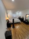 Bedroom with wood finished floors and recessed lighting