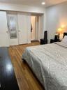 Bedroom with light wood-style flooring and baseboards