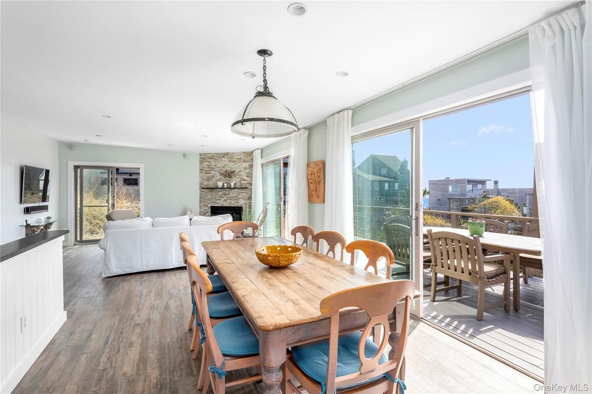 Dining space with a fireplace and wood finished floors
