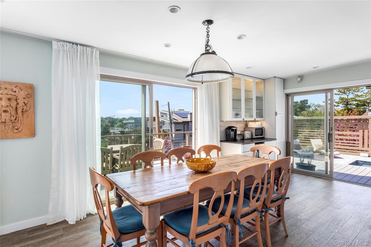 Dining room with dark wood-type flooring and baseboards