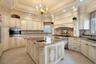 Kitchen featuring cream cabinetry, light stone counters, light tile patterned floors, recessed lighting, and stainless steel appliances