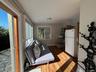Living area with baseboards and dark wood-style flooring