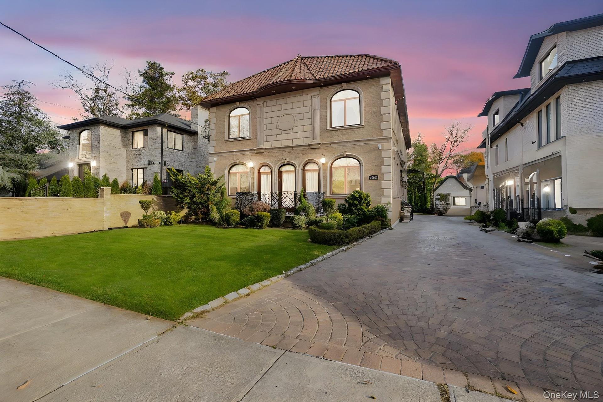 Mediterranean / spanish-style home featuring a tile roof and driveway