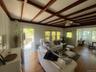 Living area with wood finished floors, beamed ceiling, ceiling fan, and coffered ceiling