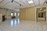 Spare room with rail lighting, a paneled ceiling, and baseboards