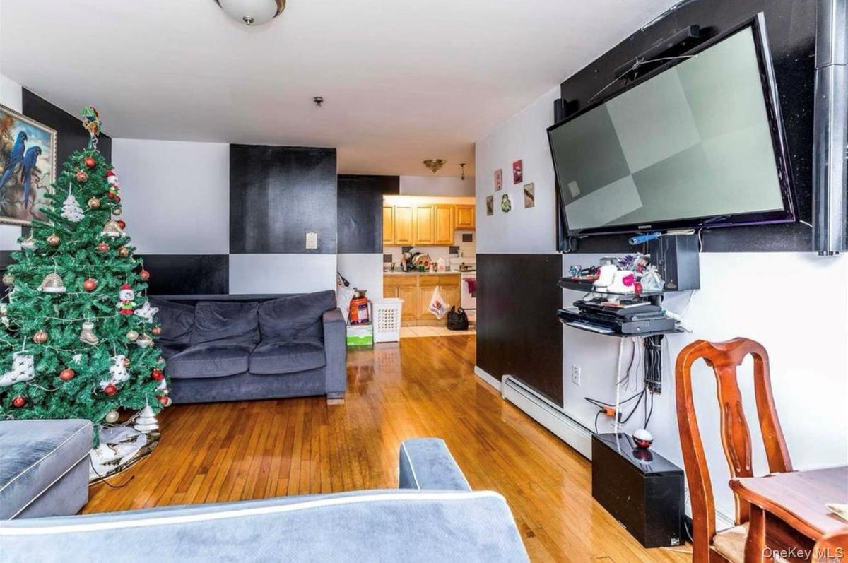 Living area featuring light wood-style floors and a baseboard heating unit