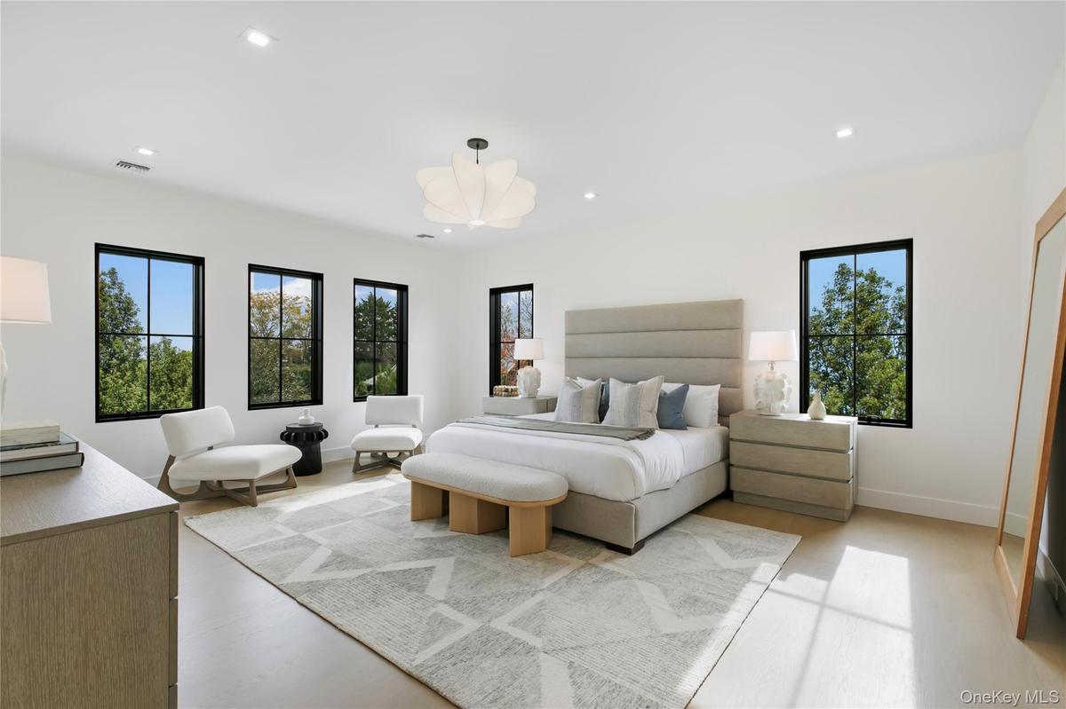 Bedroom featuring multiple windows, recessed lighting, and light wood finished floors