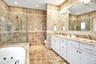 Second Floor Primary Bathroom en-suite featuring tile walls, double vanity, recessed lighting, a whirlpool tub, and a tile shower