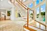 Stairs featuring recessed lighting, a towering ceiling, and inlaid floor details