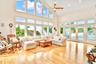 Living room featuring high vaulted ceiling, light wood-style floors, a ceiling fan, and recessed lighting