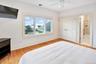 Third Oceanfront Bedroom featuring light wood-type flooring, ceiling fan, ensuite bathroom, recessed lighting, and a closet
