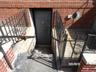 Doorway to property featuring brick siding