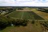 Aerial overview of property's location featuring rural landscape and farmland